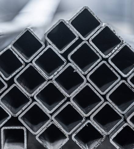 Steel tube, square high carbon metal tube for construction site. Metallurgy background.